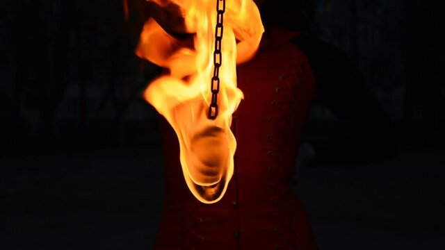 A Fire Artist Moves His Fire Pois Right And Left