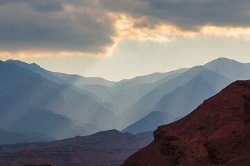 Naklejka premium Mysterious landscape in the Quebrada de las Conchas with haze over the mountain ridges