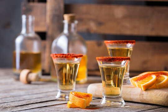 Mexican mezcal or mescal shot with chili pepper and orange