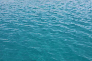 Blue water ripples. Wonderful swim in clean turquoise sea water. Scenic backdrop with beautiful transparent water of the Red Sea with sun shine.