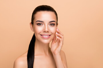 Photo of optimistic brunette hairdo lady touch face without clothes isolated on pastel beige color background