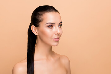 Profile photo of optimistic brunette hairdo lady look empty space without clothes isolated on pastel beige color background