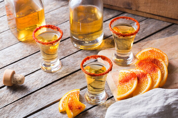 Mexican mezcal or mescal shot with chili pepper and orange