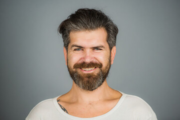 Fototapeta premium Bearded man smile face. Barbershop. Handsome smiling young guy. Human facial expressions and emotions.