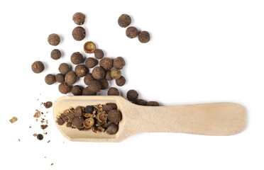 Allspice, pimento spice, Jamaican pepper in wooden spoon isolated on white background, top view