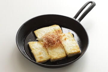 Japanese food, pan fried tofu and Katsuobushi in skillet pan