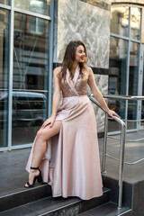 Fashion full-length portrait pretty lady in attractive ball gown dress at city street