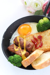 hashed brown and sausage with sunny side up fried egg for gourmet breakfast