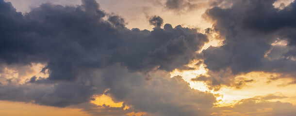 Naklejka na ściany i meble Overcast sunset sky with dark cloud in windy day.