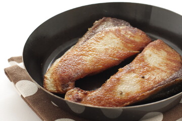 Chinese food, pan fried yellow tail fish fillet on pan