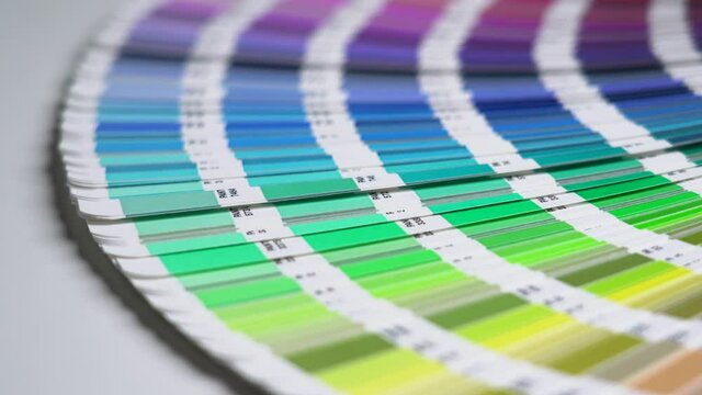 Close-up on color palette guide for printing and painting. Horizontal video of the catalog of color samples to be chosen for graphic, painting, printing a new creative business work. 