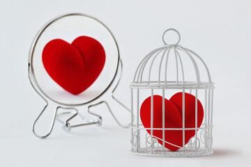 Heart in a cage looking in the mirror and seeing itself free - Concept of love and freedom