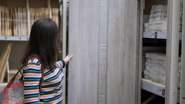 Woman Choosing Interroom Doors for her Home in a Store. Home Improvement, Renovation and Redecoration Concept