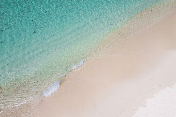Aerial top view of ocean wave on  sand beach