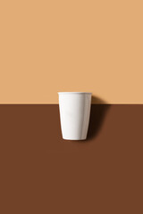 Mug or cup of coffe to go porcelain on brown background