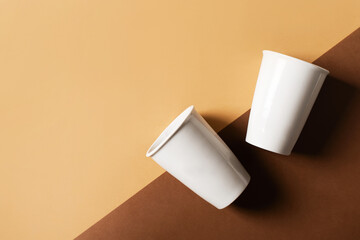 Mug or cup of coffe to go porcelain on brown background