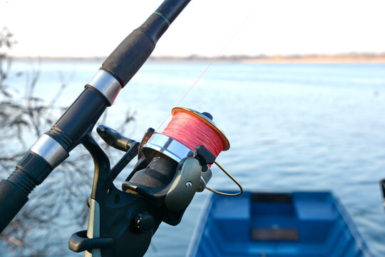 ishing reel on the rod. Fishing on the feeder. Carp fishing rods with carp bite indicators and reels set up on rod pod near lake river.