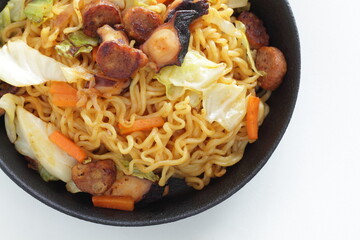 Chinese food, octopus and sausage stir fried with cabbage noodles in skillet pan