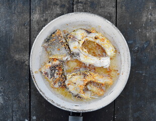 fried pieces of carp fish in a pan.