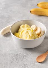 Banana homemade ice cream bowl with fruit, vegetarian concept food, copy space