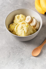 Banana homemade ice cream bowl with fruit, vegetarian concept food, copy space