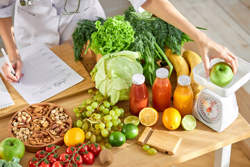 Dietologist writing healthy diet plan for patient with healthy fruit and vegetable on table, Right nutrition concept