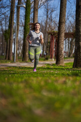 Fototapeta premium Plus size woman running in the park