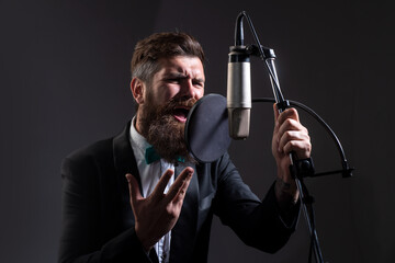 Music festival. Singer performing a song with a microphone while recording in a music studio.