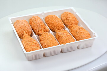 Frozen breaded surimi crab claws  isolated on white. Frozen food.