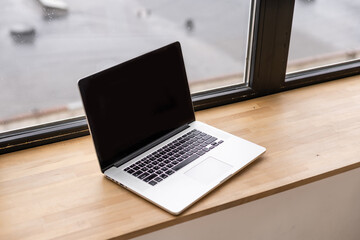 Laptop with blank screen on table