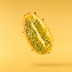 Fresh ripe kiwano falling in the air isolated