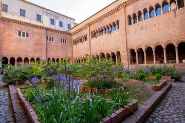 The European garden inside the cloister of the Basilica of San Lorenzo,with long corridor built in...
