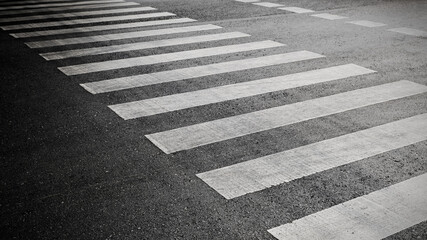 crosswalk on the road for safety when people walking cross the street, Pedestrian crossing on a repaired asphalt road, Crosswalk on the street for safety, logistic import export and transport industry