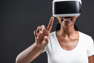 Woman with VR headset touching invisible screen