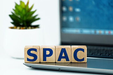 photo on spac (special purpose acquisition company) theme. wooden cubes with the abbreviation...