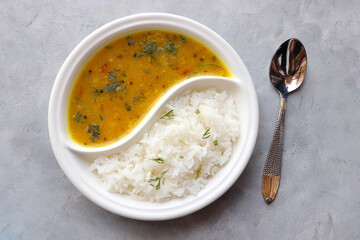 Healthy nutritious Indian comfort food Dal Chawal thali or Dal Rice, also commonly known as Varan bhat in Marathi. Served in two way ceramic plate. Over white background with copy space.