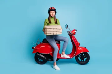 Foto op Plexiglas Full length profile photo of pretty friendly girl hands hold pizzas sit on moped isolated on blue color background © deagreez