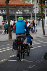 Father and son biking in the city