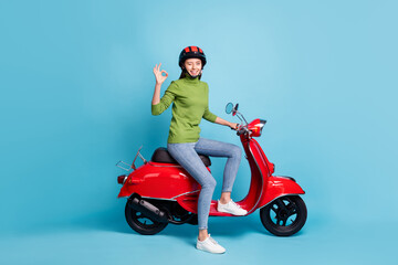 Fototapeta na wymiar Full body profile photo of attractive person sit on bike fingers show okey symbol isolated on blue color background