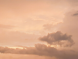 Cloudscape background with dark distinctive cloud shapes and brown golden sky.