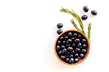 Wooden bowl of pickled black olives, top view
