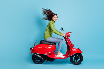 Fototapeta na wymiar Full length photo portrait of charming woman driving red scooter isolated on pastel blue colored background