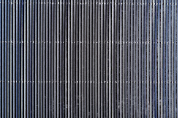 Gray abstract striped background. Rough texture. Perforated paper