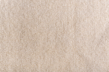 Beige homogeneous background. Milky fabric. Textile surface. Terry towel