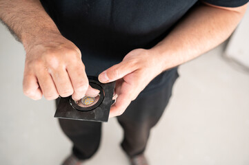 Professional electrician prepares an LED bulb to install in a home.Close up,Top view