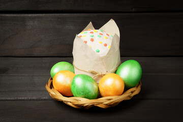 Fototapeta na wymiar Easter cake and colorful eggs on a dark. Easter motives