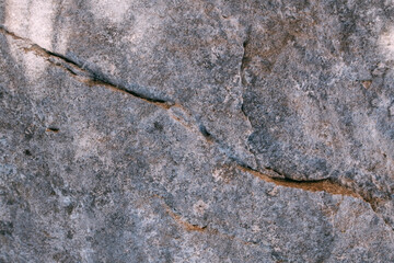 The texture of a large stone, part of a rock on a sunny day. Close-up. Macro