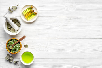 Essential oil in glass bottle, herbs with eucalyptus. Space for text