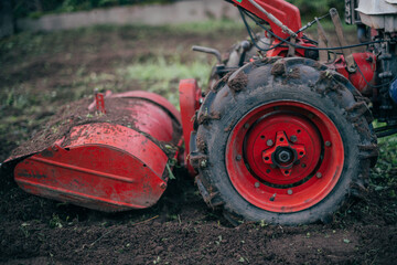 Small tractor cultivator. Hand tractor wheel on the ground