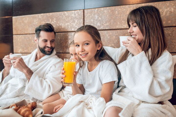 Girls drinking orange juice and looking happy